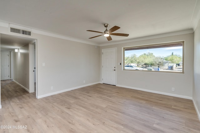 empty room featuring crown molding, ceiling fan, and light wood-type flooring