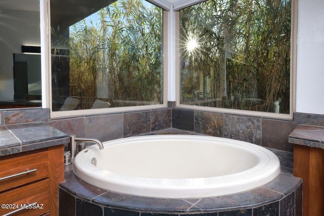 bathroom featuring vanity and a garden tub