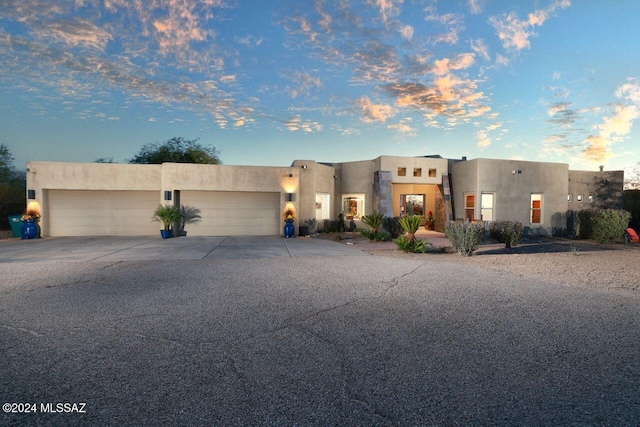 pueblo-style home with a garage