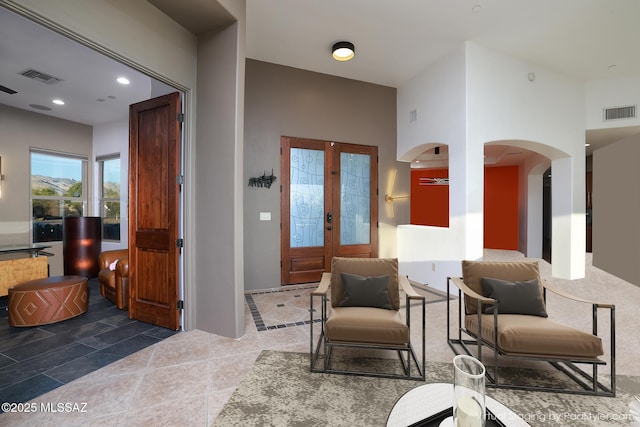 entryway with recessed lighting, visible vents, arched walkways, and french doors