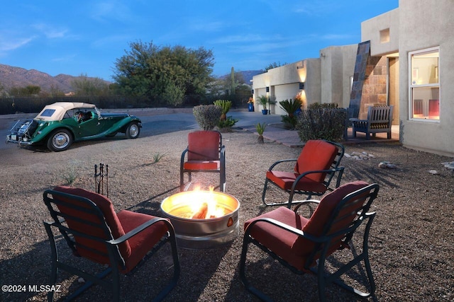 view of patio / terrace with a mountain view and a fire pit