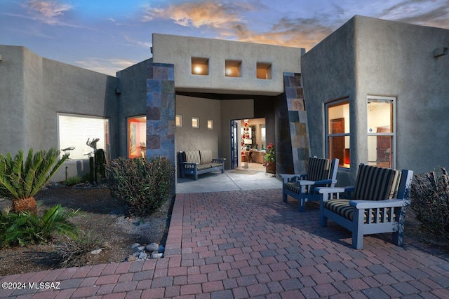 view of patio terrace at dusk