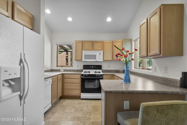 kitchen featuring a healthy amount of sunlight, white appliances, kitchen peninsula, and vaulted ceiling