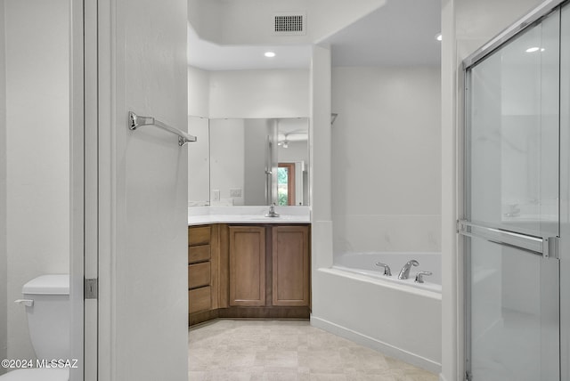 full bathroom with plus walk in shower, vanity, and toilet