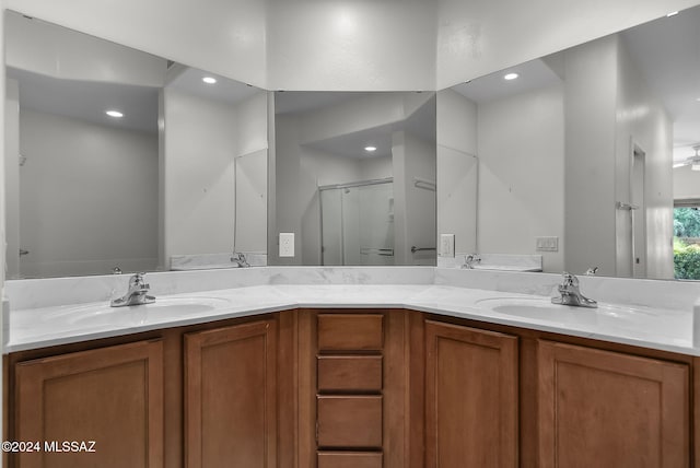 bathroom featuring vanity and a shower with shower door