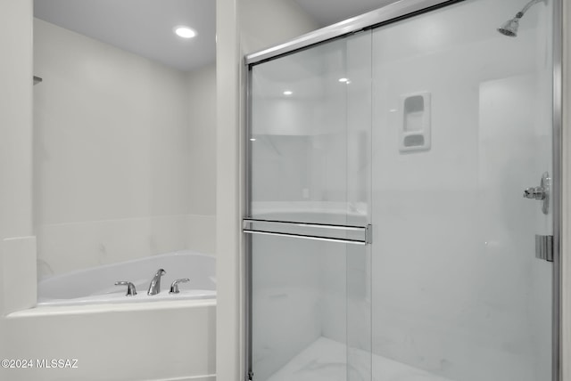 bathroom featuring plus walk in shower