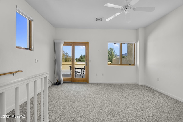 carpeted spare room with ceiling fan