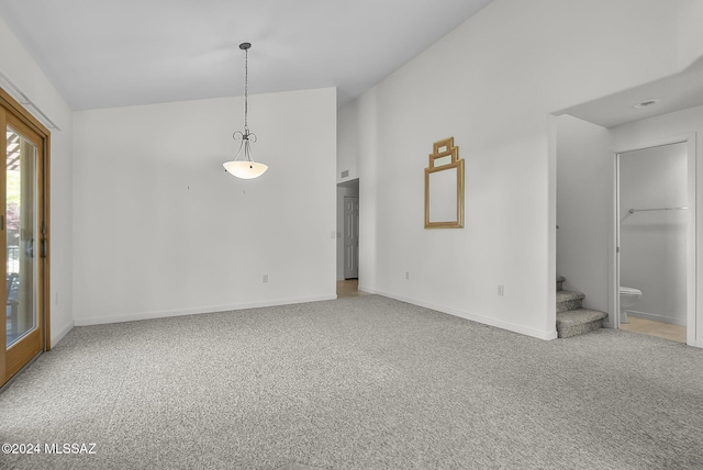 unfurnished room with carpet and lofted ceiling