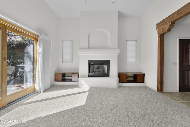 unfurnished living room featuring light carpet