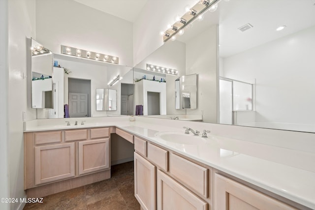 bathroom with vanity and a shower with shower door