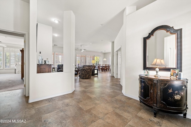 corridor with carpet flooring and plenty of natural light