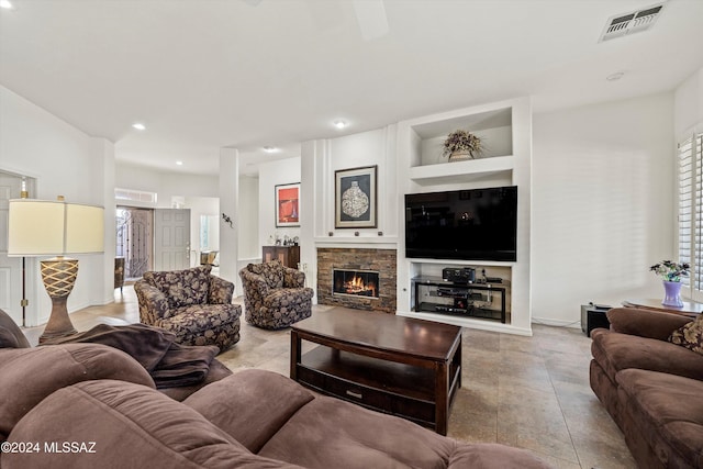 living room with a fireplace and built in features