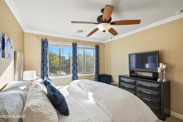 carpeted bedroom featuring ceiling fan and crown molding