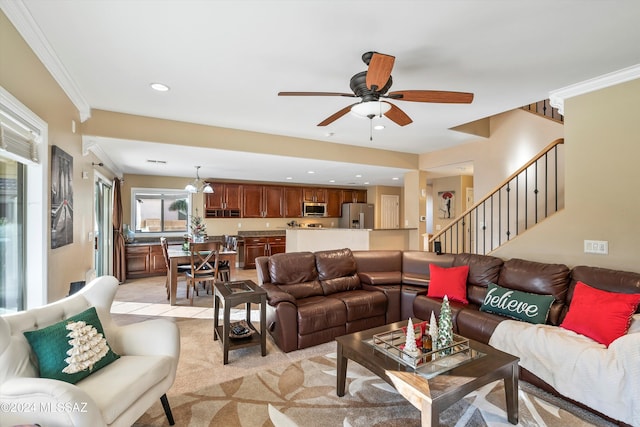 carpeted living room featuring crown molding and ceiling fan with notable chandelier