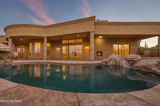 pool at dusk featuring a patio area