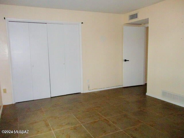 unfurnished bedroom with a closet