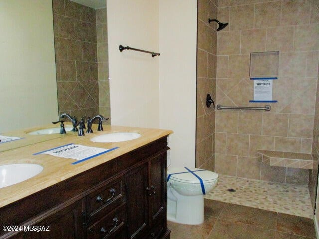 bathroom featuring tile patterned flooring, vanity, and toilet