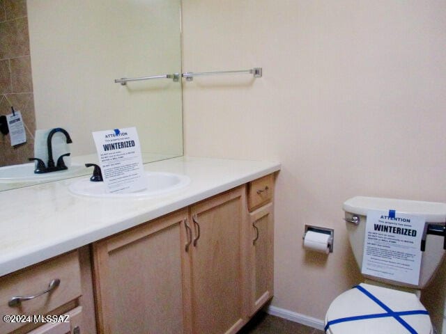 bathroom featuring vanity and toilet