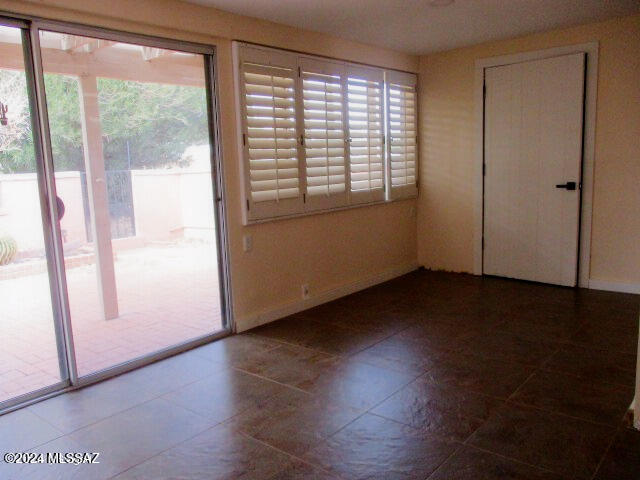 interior space with a closet and dark tile patterned floors