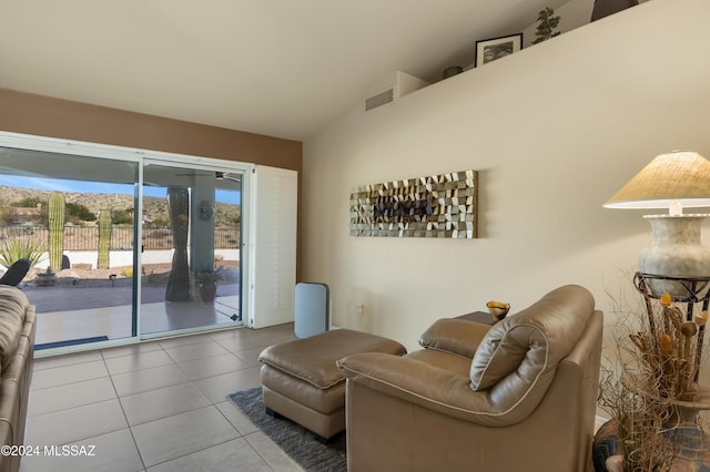 tiled living room featuring vaulted ceiling