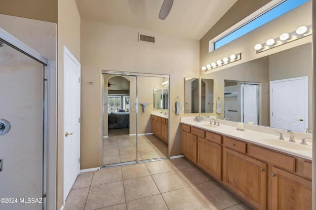 bathroom with vanity, lofted ceiling, tile patterned floors, ceiling fan, and walk in shower