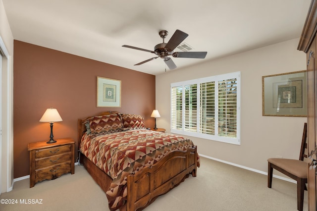 bedroom featuring ceiling fan and light carpet