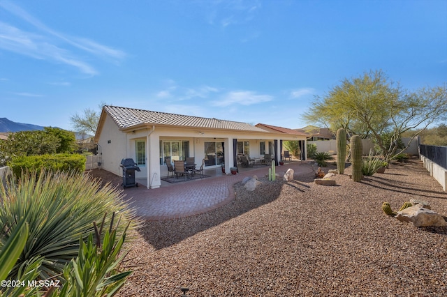 rear view of property featuring a patio area