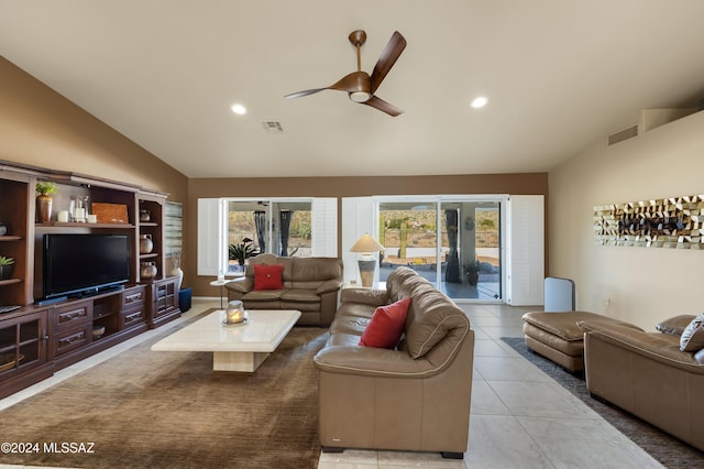 tiled living room featuring ceiling fan and lofted ceiling