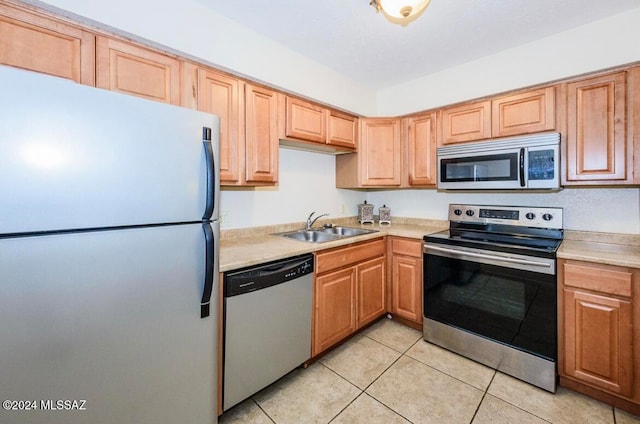 kitchen featuring sink, light tile patterned floors, and appliances with stainless steel finishes