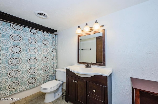 bathroom featuring tile patterned floors, vanity, and toilet