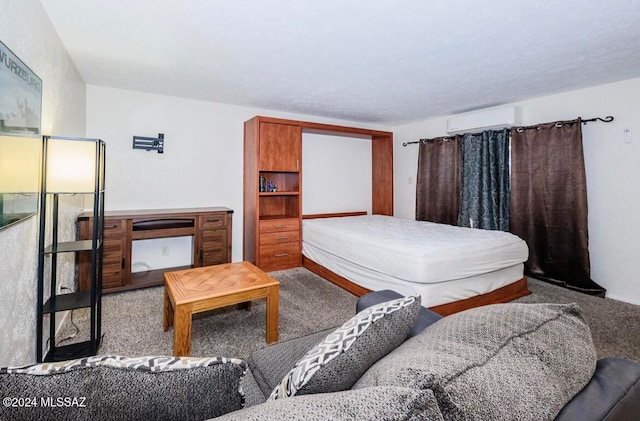 bedroom with carpet floors and an AC wall unit