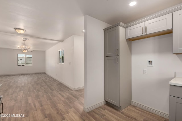 kitchen featuring baseboards, gray cabinetry, visible vents, and light wood-type flooring