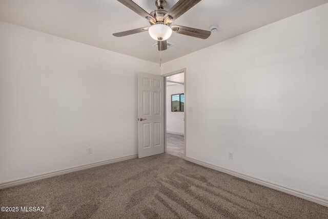 empty room featuring baseboards, a ceiling fan, and carpet flooring