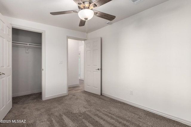 unfurnished bedroom featuring carpet flooring, visible vents, baseboards, a ceiling fan, and a closet