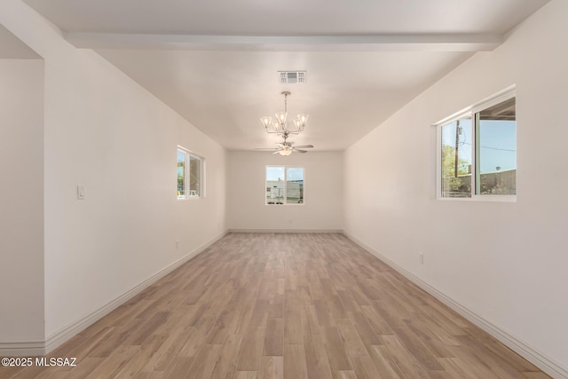 empty room with light wood-style floors, visible vents, baseboards, and a notable chandelier