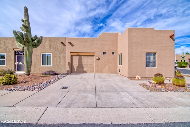 southwest-style home featuring a garage