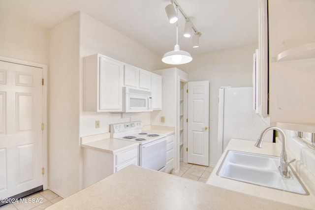 kitchen featuring sink, white cabinets, light tile patterned flooring, and white appliances