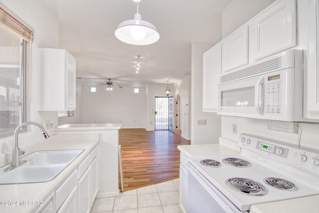 kitchen featuring white appliances, ceiling fan, sink, light hardwood / wood-style floors, and white cabinetry