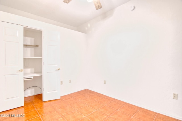 unfurnished bedroom featuring ceiling fan and light tile patterned flooring