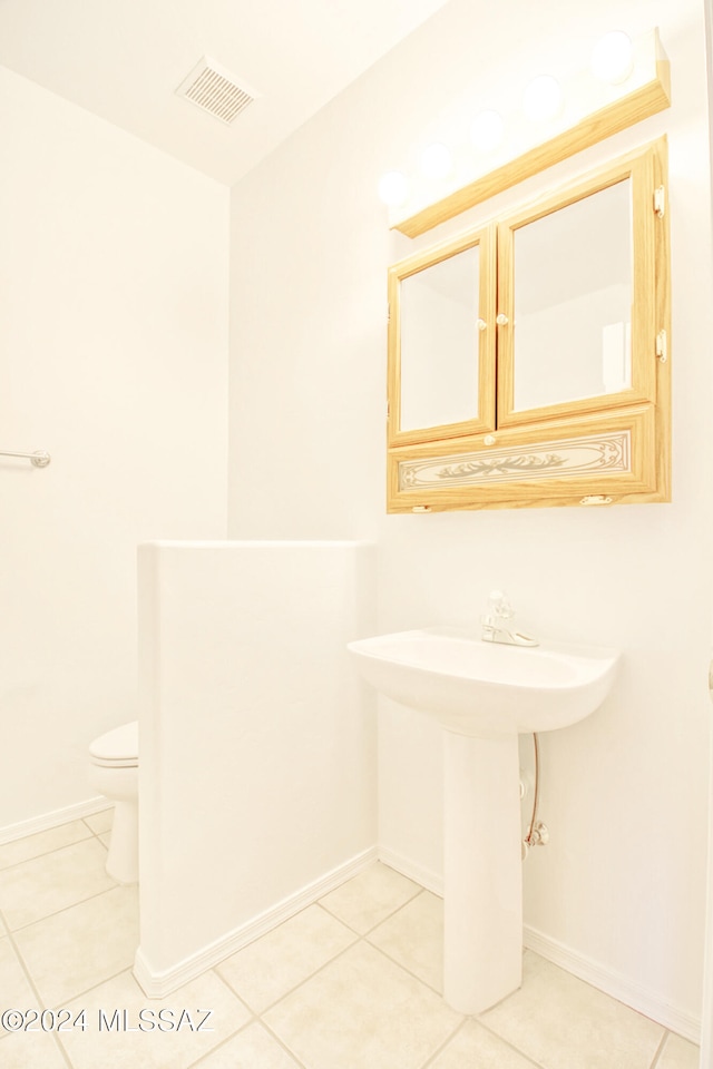 bathroom featuring tile patterned floors and toilet