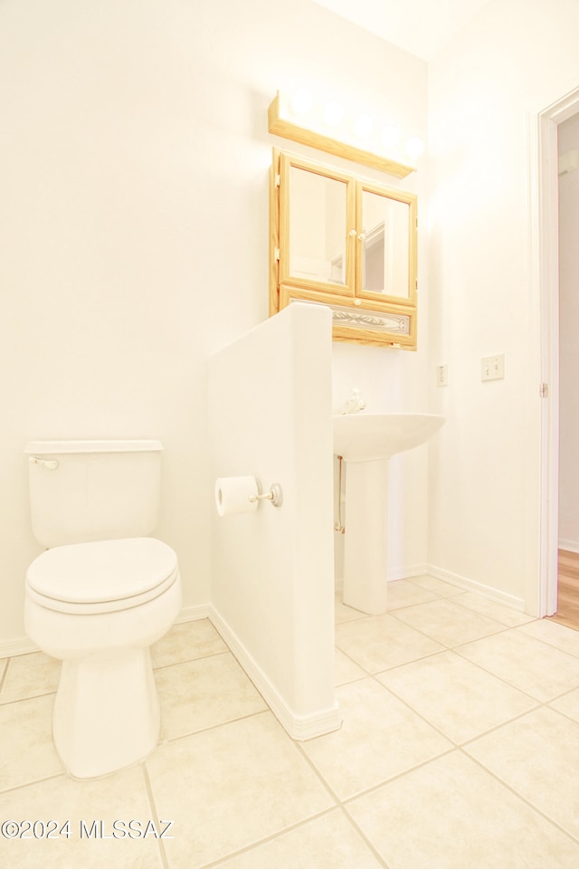 bathroom featuring tile patterned flooring and toilet