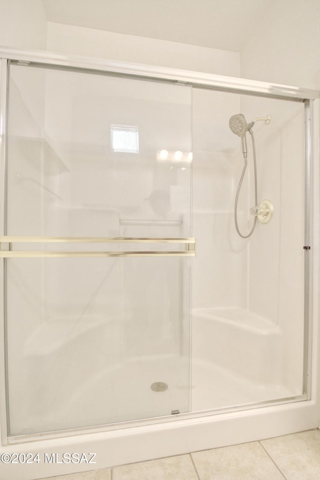 bathroom featuring tile patterned floors and an enclosed shower