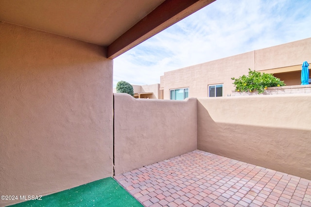 view of patio featuring a balcony