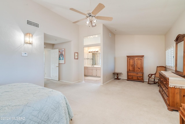 carpeted bedroom with ceiling fan and connected bathroom