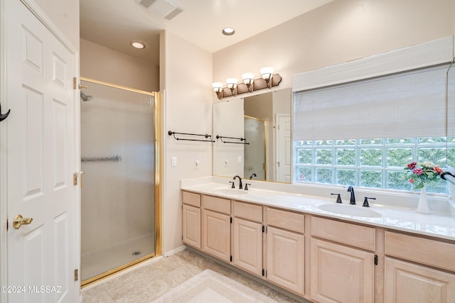 bathroom featuring tile patterned flooring, vanity, and a shower with shower door