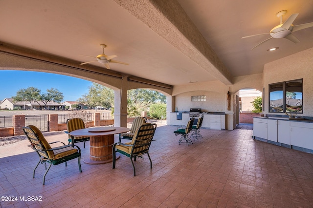 view of patio / terrace featuring ceiling fan and an outdoor kitchen