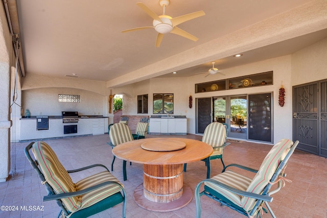 view of patio / terrace featuring ceiling fan, a grill, and exterior kitchen