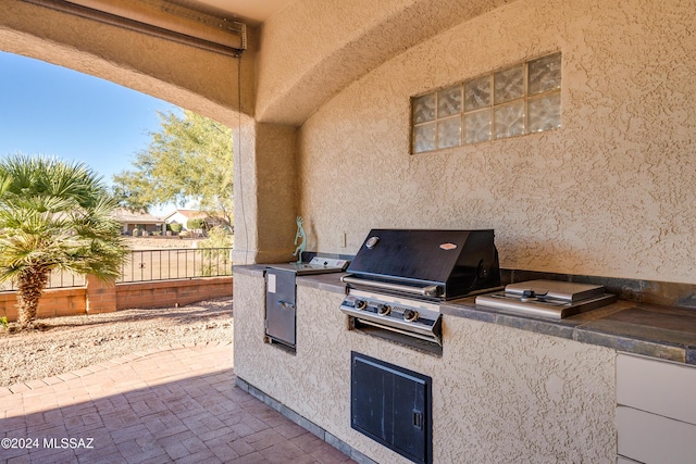 view of patio with an outdoor kitchen and area for grilling