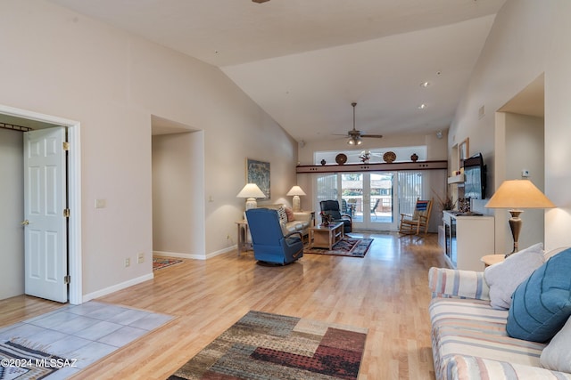 living room with light wood-type flooring, high vaulted ceiling, and ceiling fan