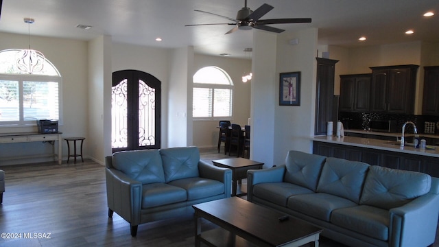 living room with french doors, dark wood-type flooring, a healthy amount of sunlight, and sink